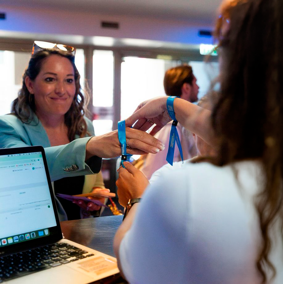 Credenciamento com entrega de pulseira em evento corporativo